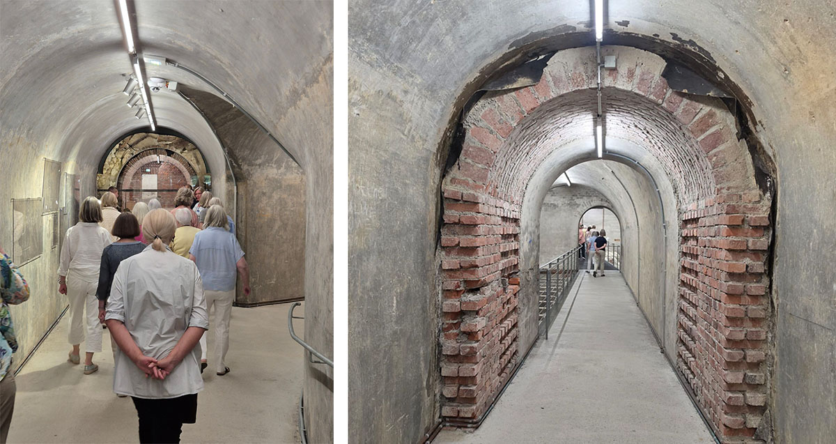 Blick auf die Gruppe von hinten und ihren Gang durch einen Tunnel der Bunkeranlage